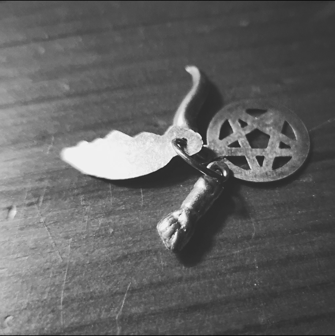 A photo of the four baby-sized charms gifted by my father.